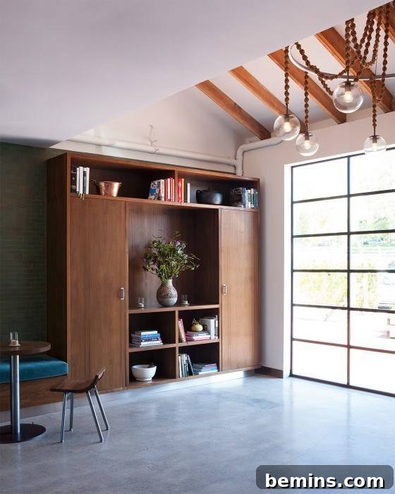 An empty room with a large white windowed wall, showcasing natural light and minimalist design.