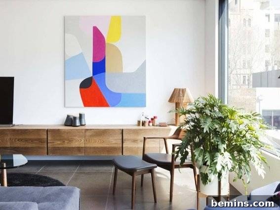 A room adorned with a multi-colored painting and a potted fern, showcasing a harmonious blend of art and nature.