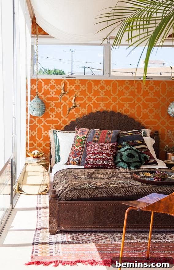 A sun-drenched bedroom featuring a vibrant orange headboard, creating a warm and inviting atmosphere.