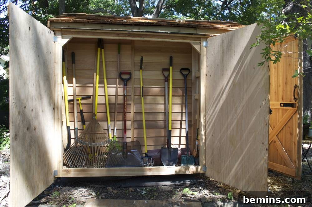 An outdoor shed with hanging garden tools: Showcasing the organized storage of gardening tools on the exterior of the shed.