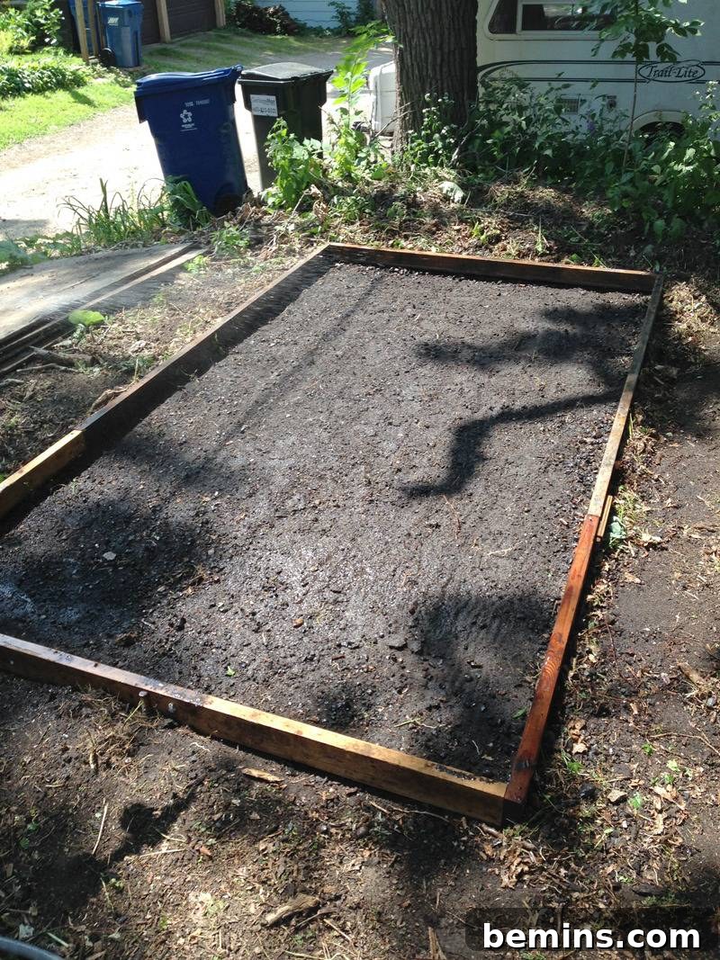 Wooden slats forming a rectangle: Holding poured concrete in place for the shed foundation.