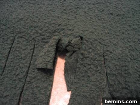 A fuzzy black carpet that has been cut up.