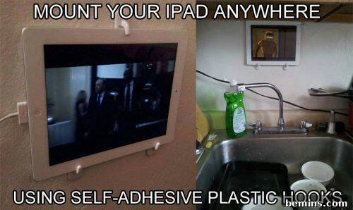 An ipad mounted to the wall in front of the kitchen.