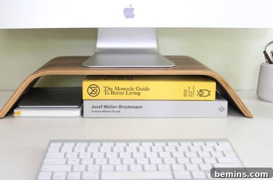 Desk Makeover: 6 Steps to a Stylish and Organized Workspace 4 Books stored under a computer stand in front of a keyboard.