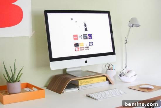 Desk Makeover: 6 Steps to a Stylish and Organized Workspace 8 A white office desk with an organized computer monitor, keyboard, and lamp.
