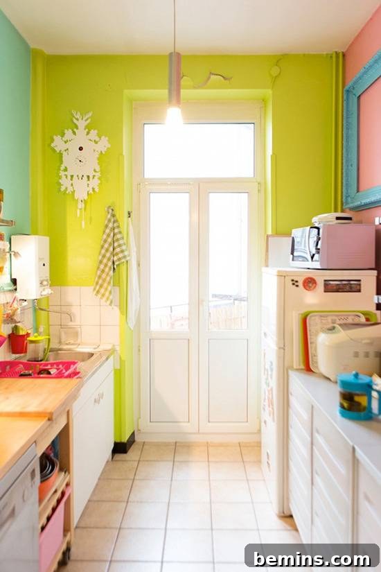 A kitchen has a white tiled floor and lime green walls.