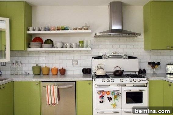 A kitchen has asparagus green cabinets next to a white oven.