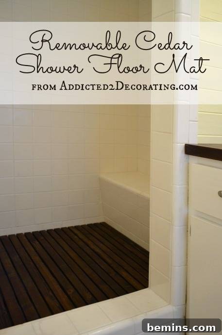 A shower area has a black floor mat, showcasing a removable cedar shower mat.