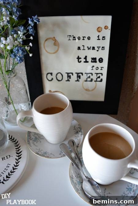 22 Stunning and Free Kitchen Wall Art Ideas 8 A cute coffee sign sitting on a pretty table setting with small glasses of cappuccino-colored coffee.