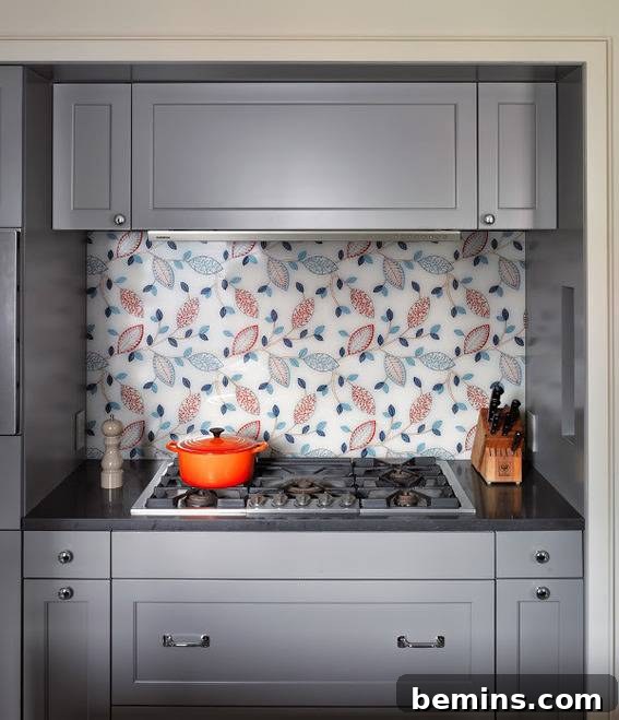 A decorative backsplash behind a grey cabinet.