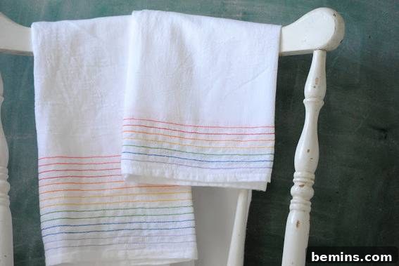 Culinary Creations: 16 Fabric DIY Projects for Home Chefs 15 A white towel hanging on a chair, showcasing a colorful rainbow-dyed design.