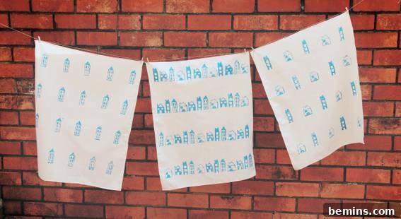 Culinary Creations: 16 Fabric DIY Projects for Home Chefs 17 White and blue designed fabrics hanging on a rope, showcasing block-printed tea towels.