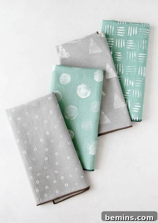 Culinary Creations: 16 Fabric DIY Projects for Home Chefs 10 Gray and teal napkins adorned with triangles, lines, and dots, showcasing creative stamping designs.