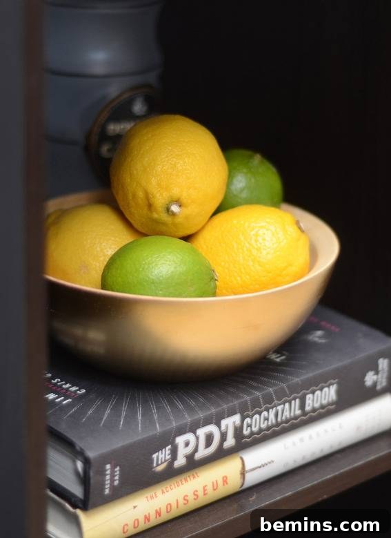 A bar cart featuring fresh lemons and limes as decorative and functional elements.