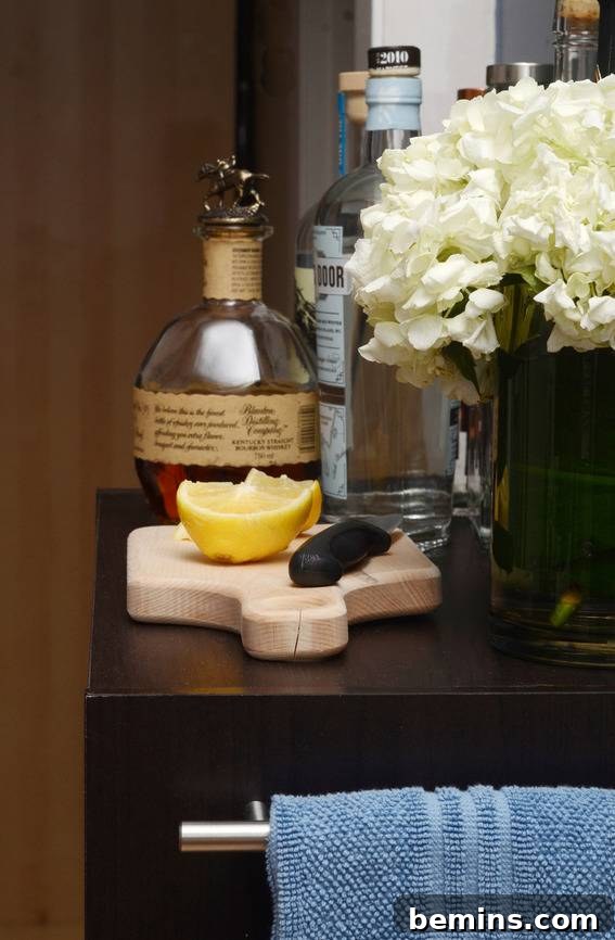 A bar cart equipped with essential bar tools, including a cocktail shaker and jigger.