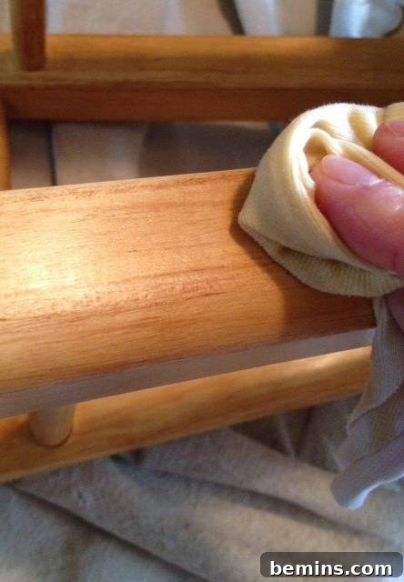 Double the Seating: A DIY Stool Split 13 Person buffing out a piece of wood. Preparing the legs of the stool with Danish oil.