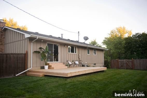 From Cluttered to Chic: A Backyard Deck Transformation 4 Newly constructed deck with stairs leading to the house and a lush green lawn.
