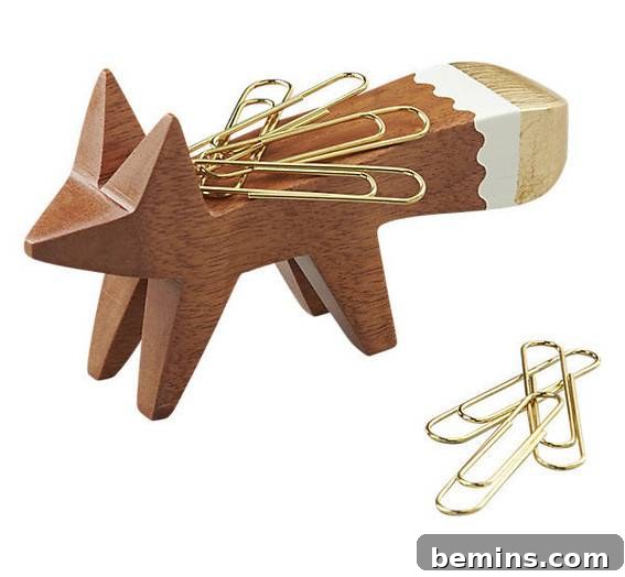A wooden paper clip holder shaped like a fox.