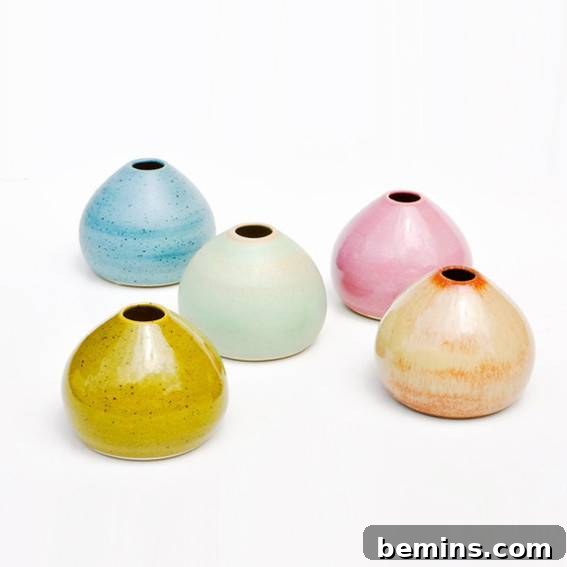 A close-up of five colorful ceramic ornaments.