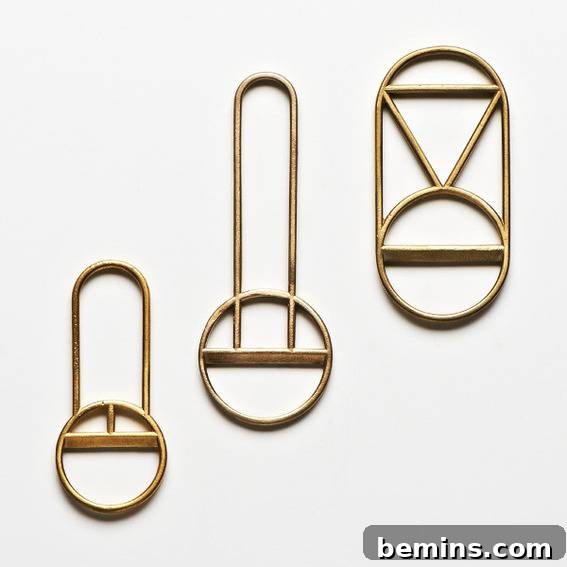 A close up of three brass bottle openers.