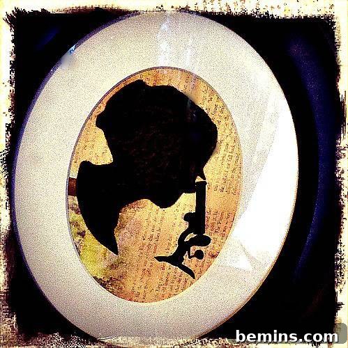 A white oval frame showcasing a woman's silhouette, reimagined with steampunk elements.