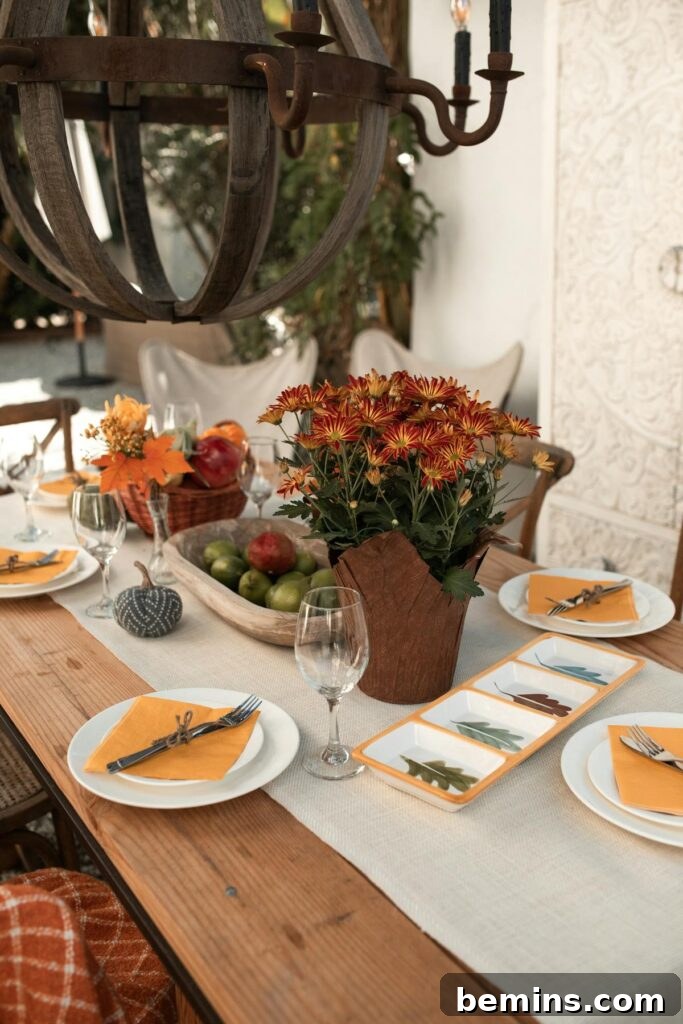 A beautifully arranged dining table with fall decor and flowers, perfect for cozy gatherings.