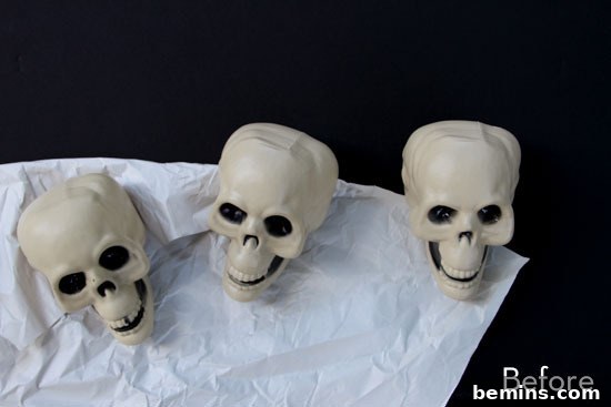 Three toy skulls on top of a white towel.