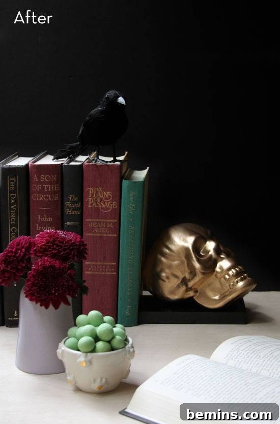 Books and decorations on a white table with skull bookends.