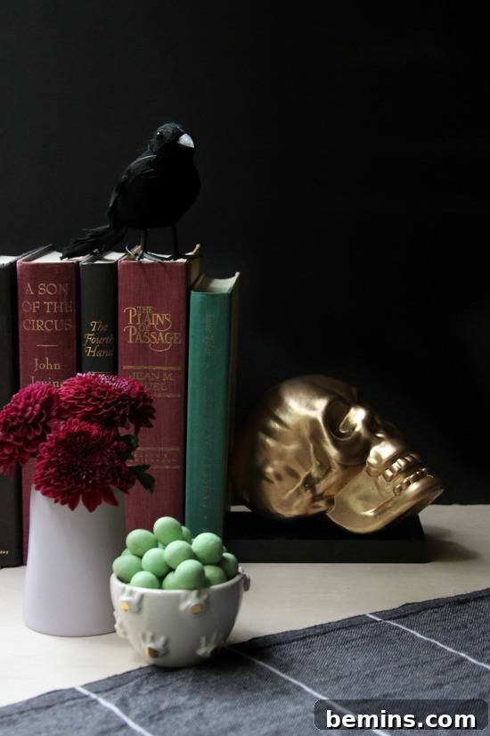 A gold skull used as a bookend on a counter.