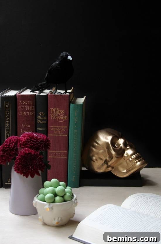 A gold skull props up books.