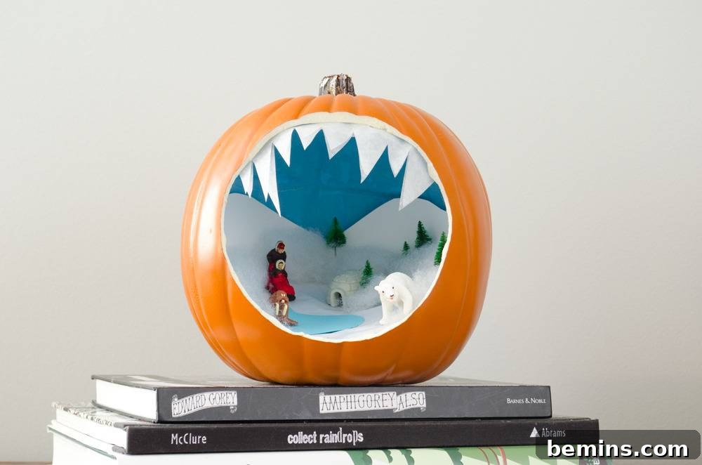 A sculpture of a jack-o-lantern  with a large hole that shows a winter scene inside, creating an arctic wonderland.