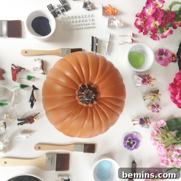 Craft supplies surrounding a pumpkin, ready for diorama creation.