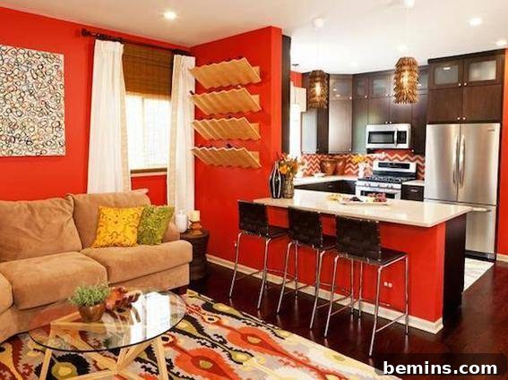 A modern living and cooking space featuring black stools under a counter, complemented by red and orange accents.