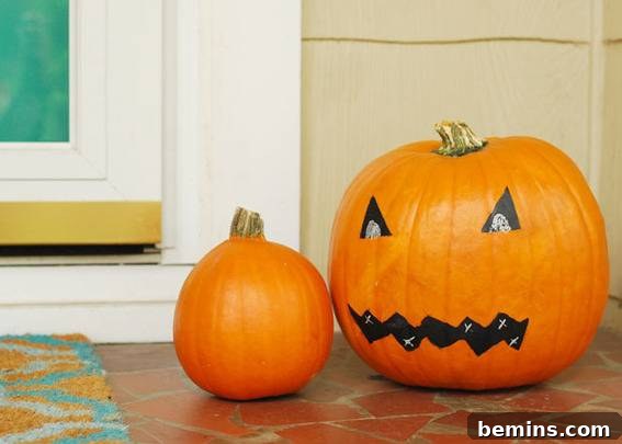 Carved pumpkin for Halloween celebration. Creative chalkboard pumpkin face DIY.