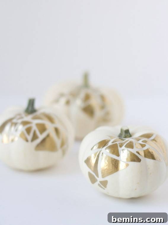 Three little pumpkins paint white with a gold leaf. Elegant gold geo painted pumpkins.