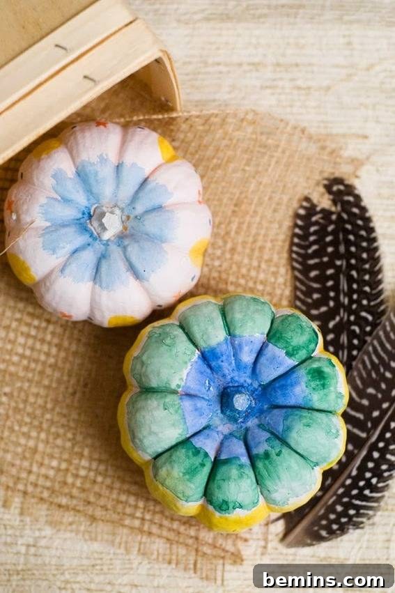 Little pumpkins painted on the top like flowers. Charming DIY watercolor pumpkins.