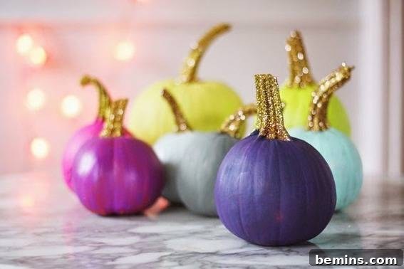 A collection of painted pumpkins. Sparkling painted pumpkins with glittered stems DIY.
