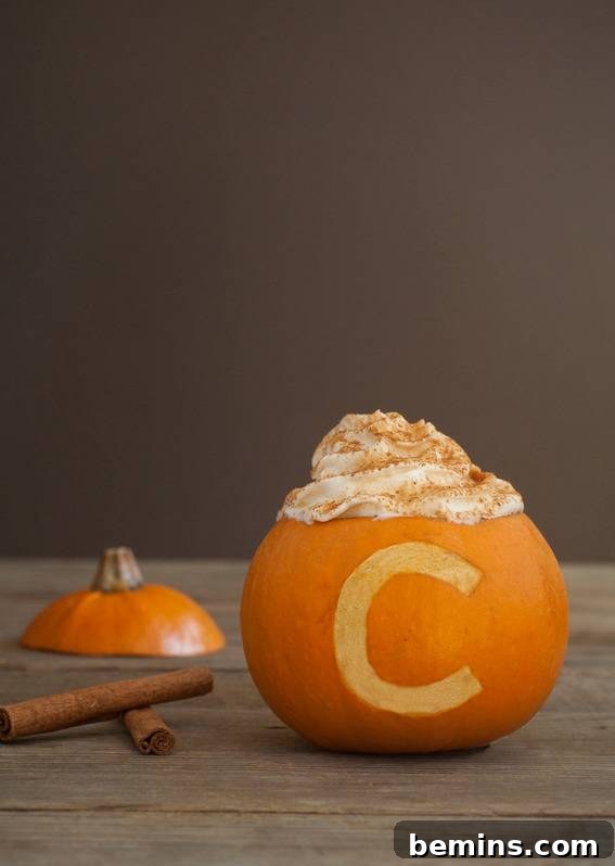 Pumpkin cup with a letter carved into the side, adding a personal touch.