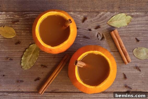Two pumpkin cups filled with juice and straws, showcasing their versatility.