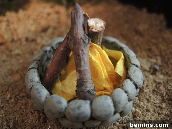 A small fire pit has yellow cloth in it.