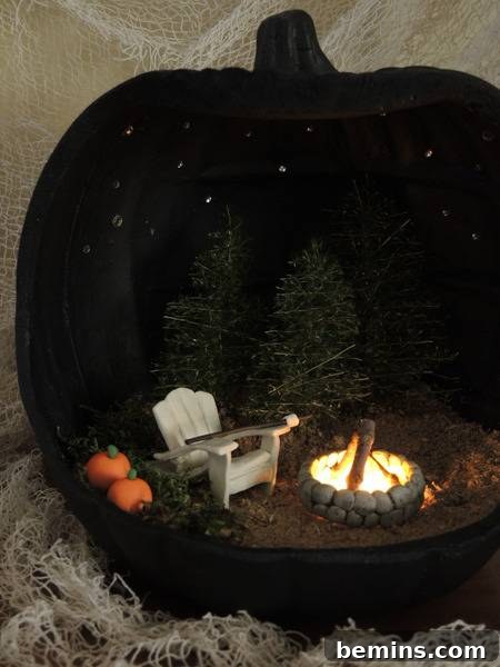 A stone fire pit with a fire in it, next to a white adirondak chair and two small pine trees, with two pumpkins next to the chair and all inside of a black pumpkin.