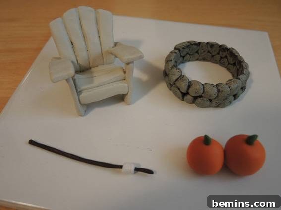 Clay figures, a lounge chair, fire pit, pumpkins, and marshmallow on a stick.
