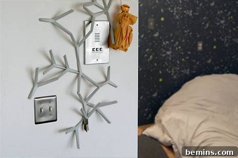 A room featuring a tree decoration, an intercom, and a pillow, showcasing a modern and inviting interior design.