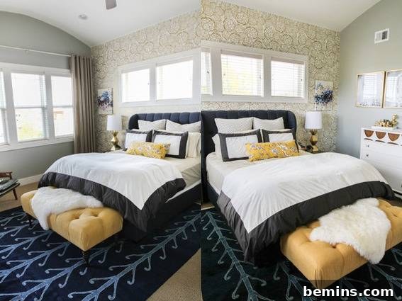 A beautifully styled bed with white and black linens, set against a vibrant blue rug and surrounded by natural light.