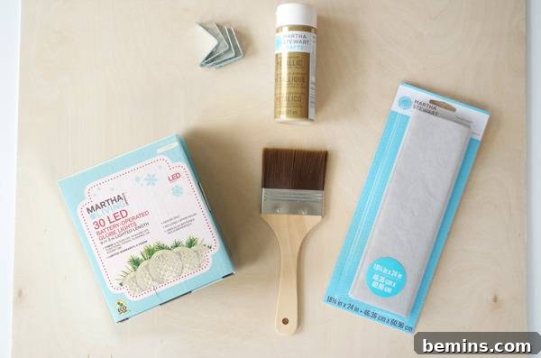 How to Design Your Own Dazzling Light-Up Sign 3 A collection of essential materials for the DIY lighted sign project, including battery-operated lights, gold paint, a paintbrush, and a fabric swatch.