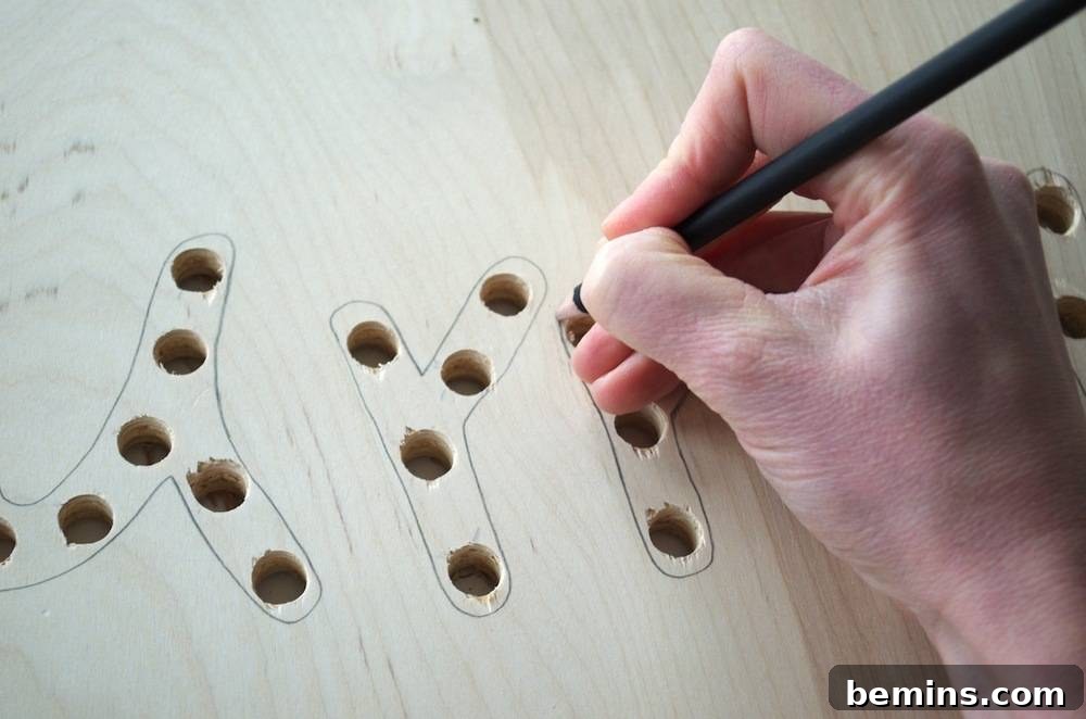 How to Design Your Own Dazzling Light-Up Sign 7 The word design painted onto the plywood, adding a festive touch to the sign.
