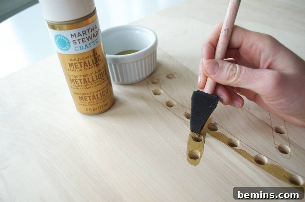 How to Design Your Own Dazzling Light-Up Sign 8 Applying a coat of vibrant acrylic paint to the outlined word design.