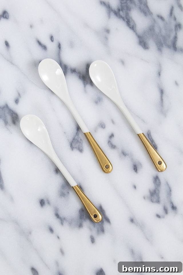 Golden Thanksgiving: 13 DIY Decor Ideas in Gold & Copper 14 White spoons with stylish gold handle tips on a white marble countertop.