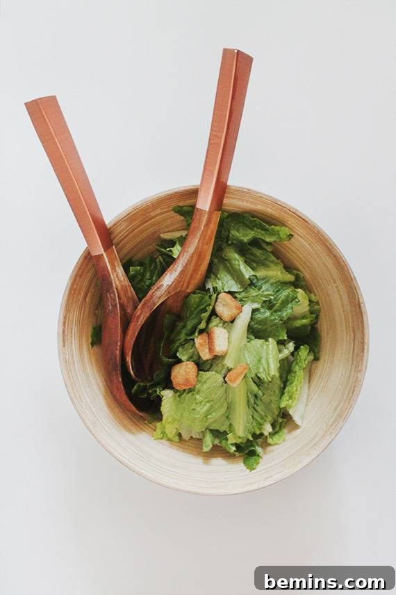Golden Thanksgiving: 13 DIY Decor Ideas in Gold & Copper 4 Close-up of copper salad servers in a bowl of green leafy vegetables.