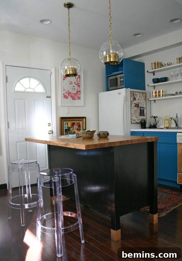 A kitchen island sits near a white door, showcasing a practical and stylish design element.